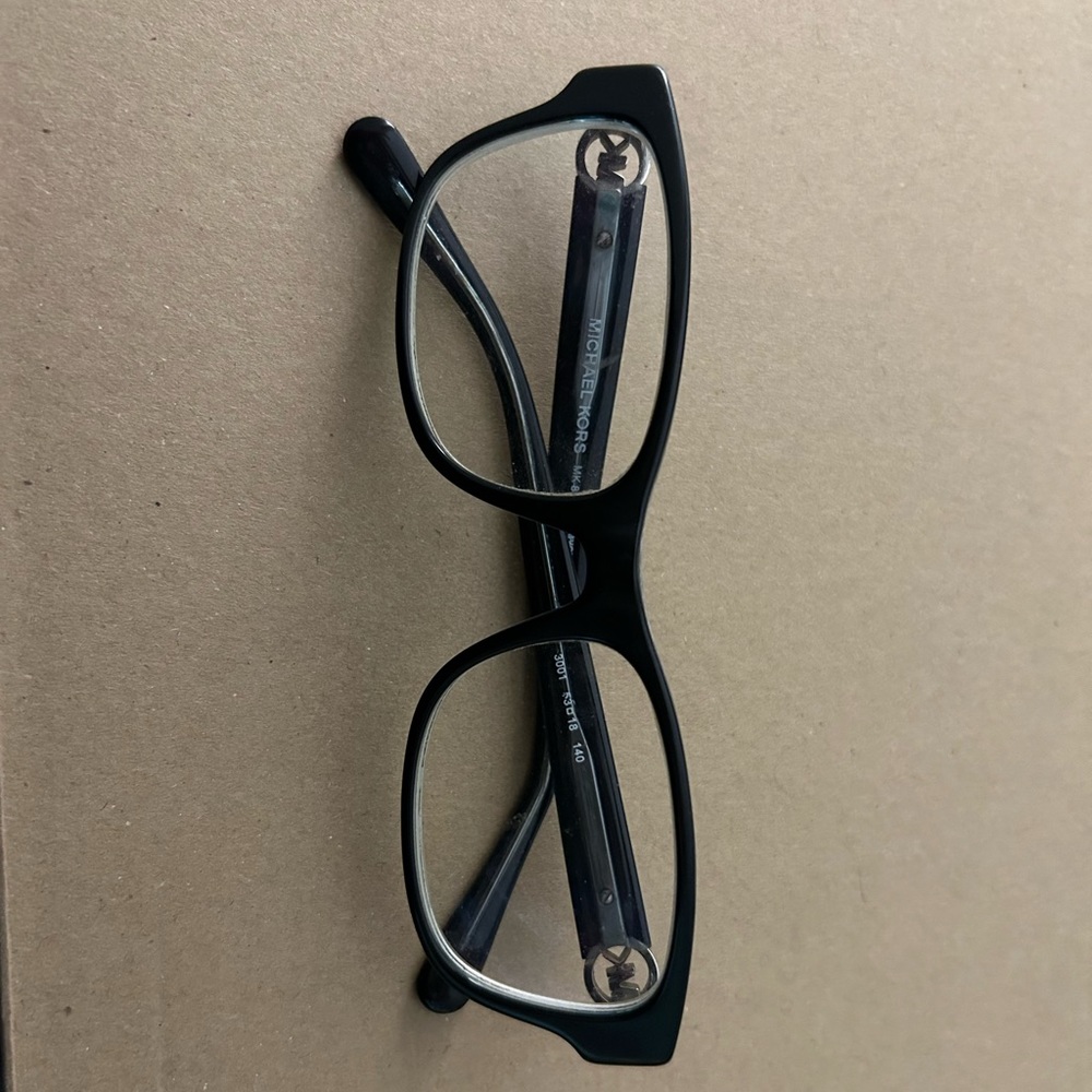 Black Michael Kors glasses.